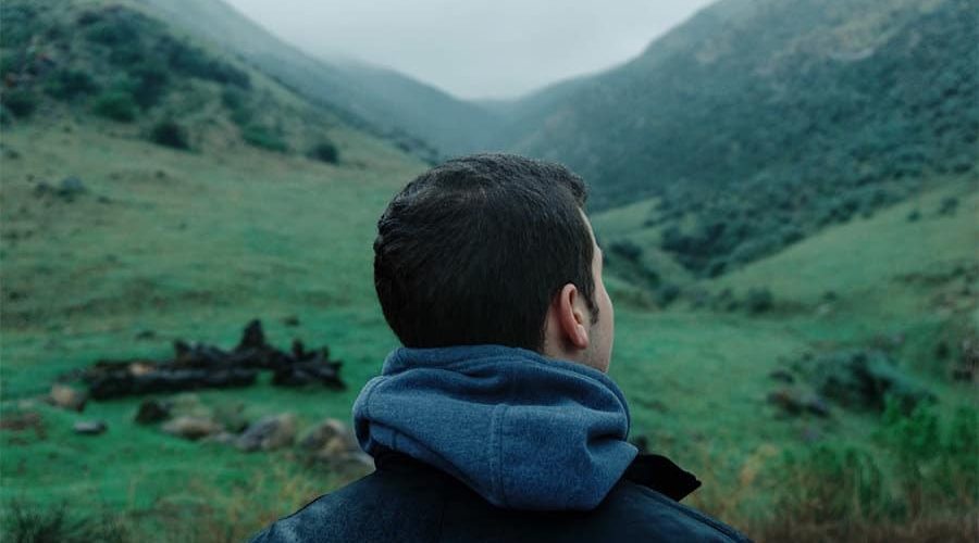 how to change your thoughts, man thinking and gazing at mountains
